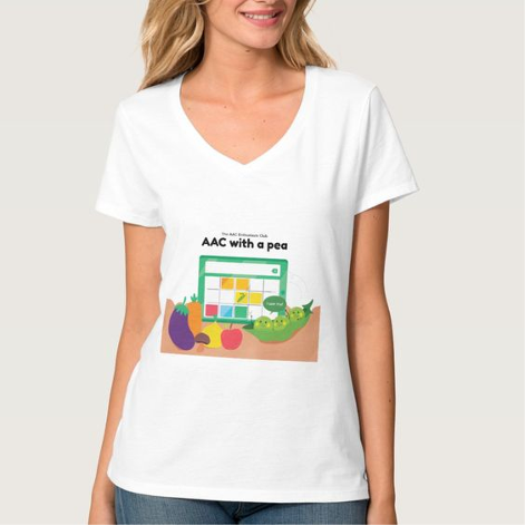 white t-shirt with “The A A C Enthusiasts Club” and “A A C with a pea”. A high-tech A A C device is on a table with a pea icon in the message window. Several fruits and vegetables with faces are in front of the A A C device. A pea in the pod has a speech bubble that says, “I see me!”.  