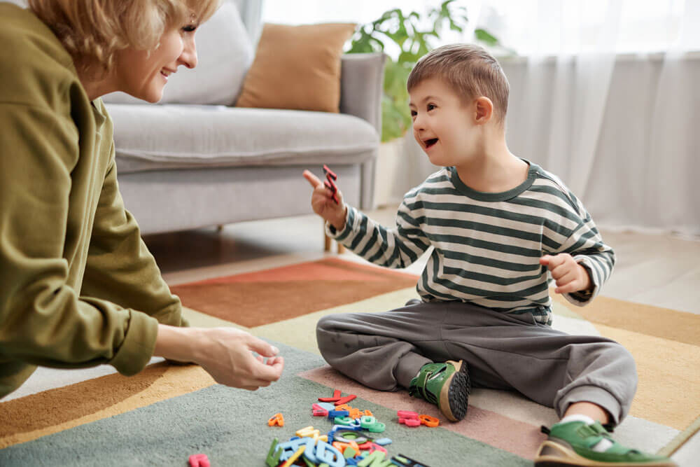 a young child and an adult having fun on the floor with plastic letters